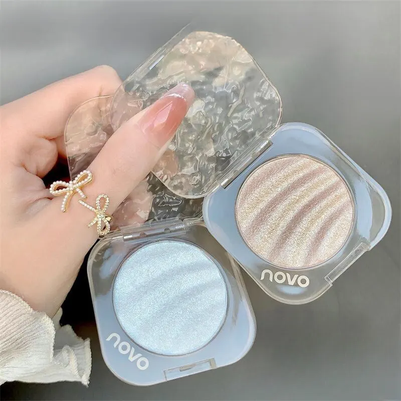 80417167-3dd4-45e0-b53e-b32138fcdd8e NOVO Highlighter Powder: Shimmer powder for brightening the face, creating a 3D contour, nose shadow, and side shadow. Fine shimmer and pearlescent finish, ideal for contouring. - Image 1