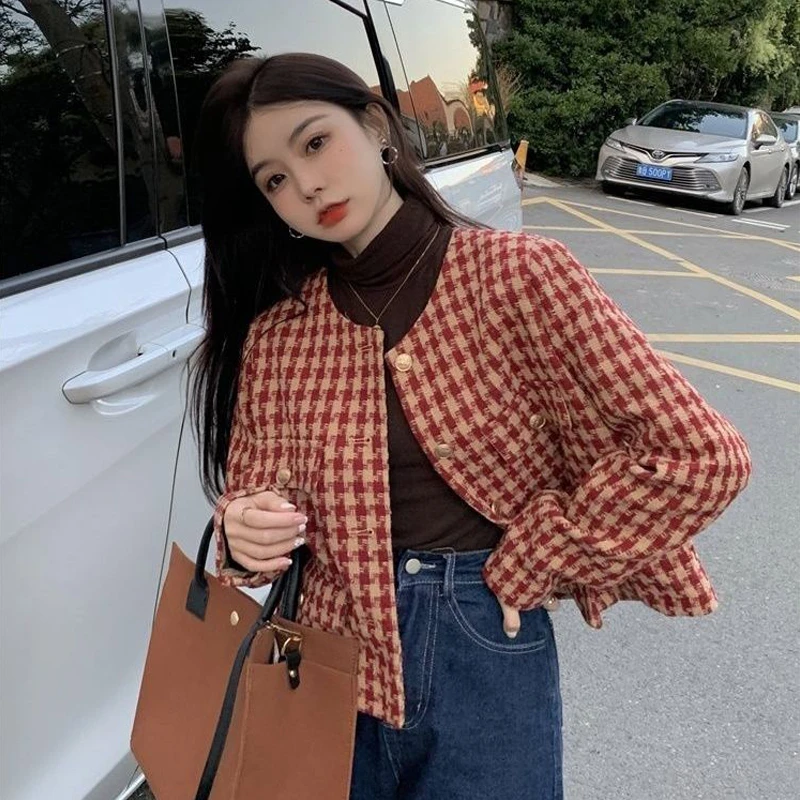 Model wearing a red and cream houndstooth cropped round-neck jacket